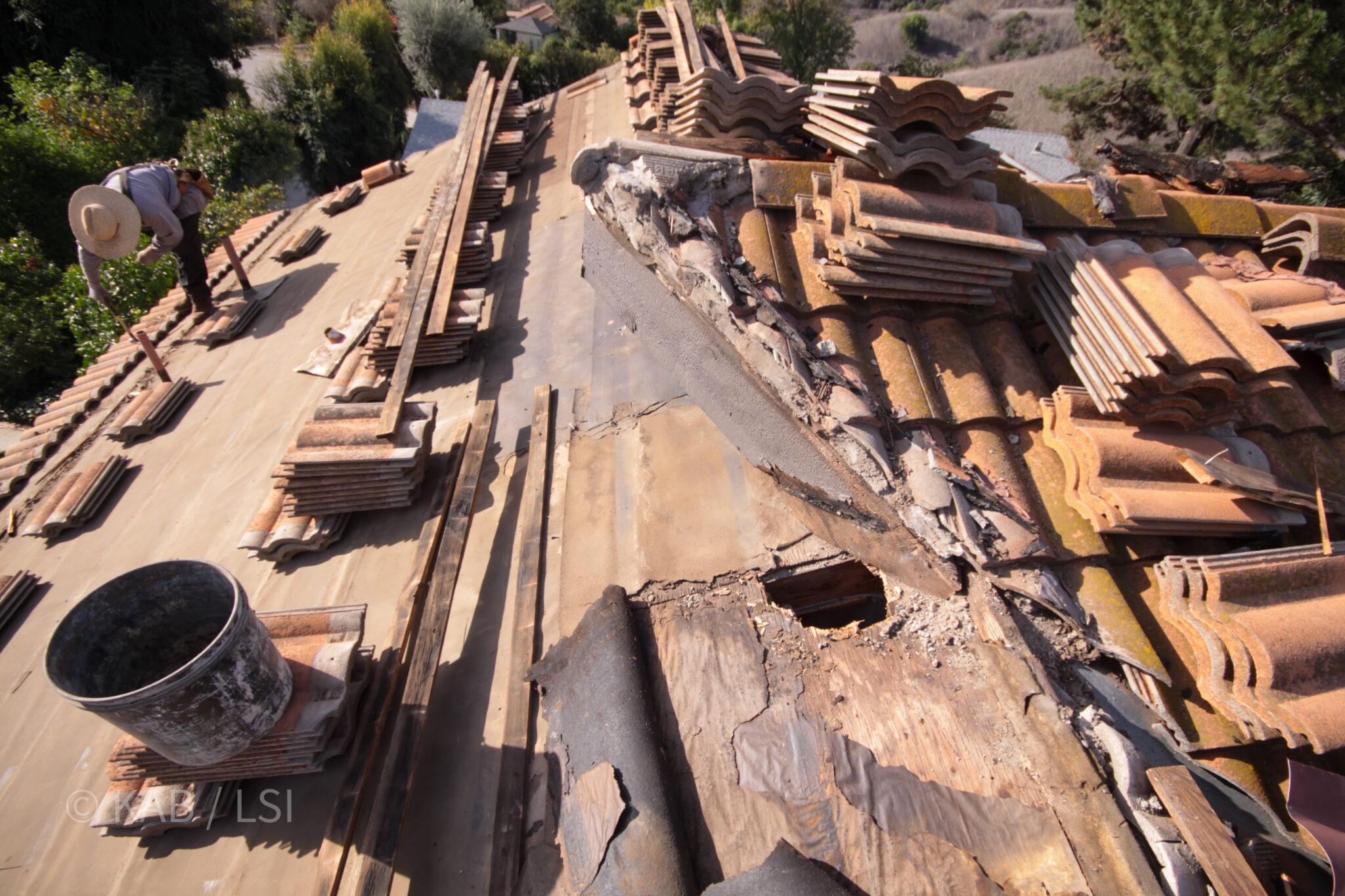 Hidden roof water damage uncovered under concrete tile on a La Habra Heights hillside home © KAB/LSI