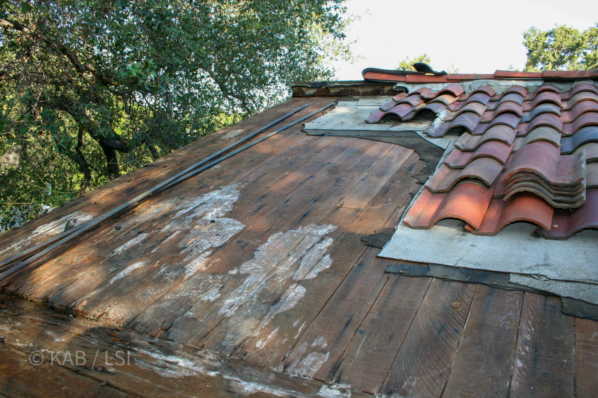 Severe roof deck deterioration revealed beneath clay S-tile roofing — what the honest inspection finds © KAB/LSI
