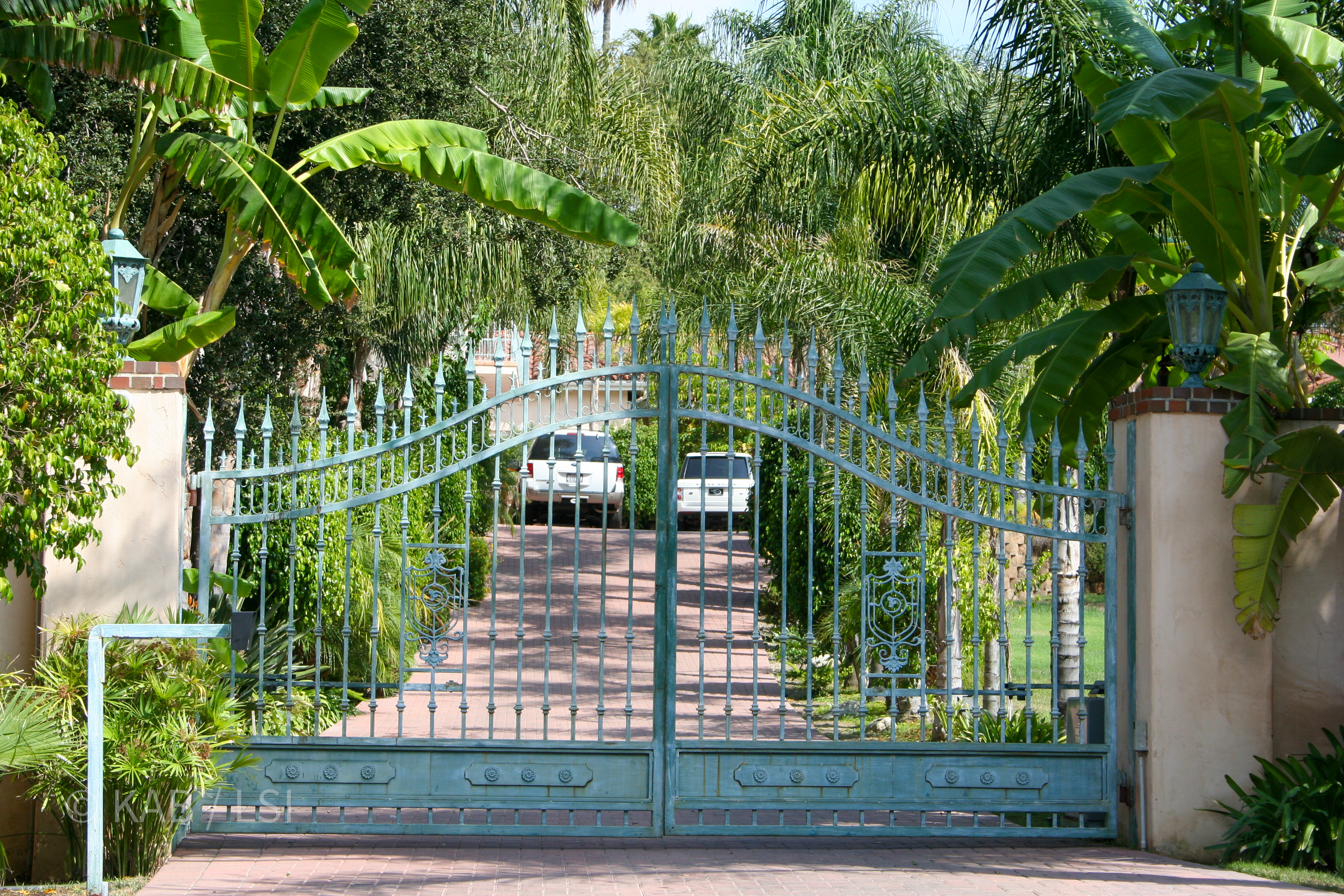 Entrance gates, fence line, security cameras and coyote-proof perimeter iron