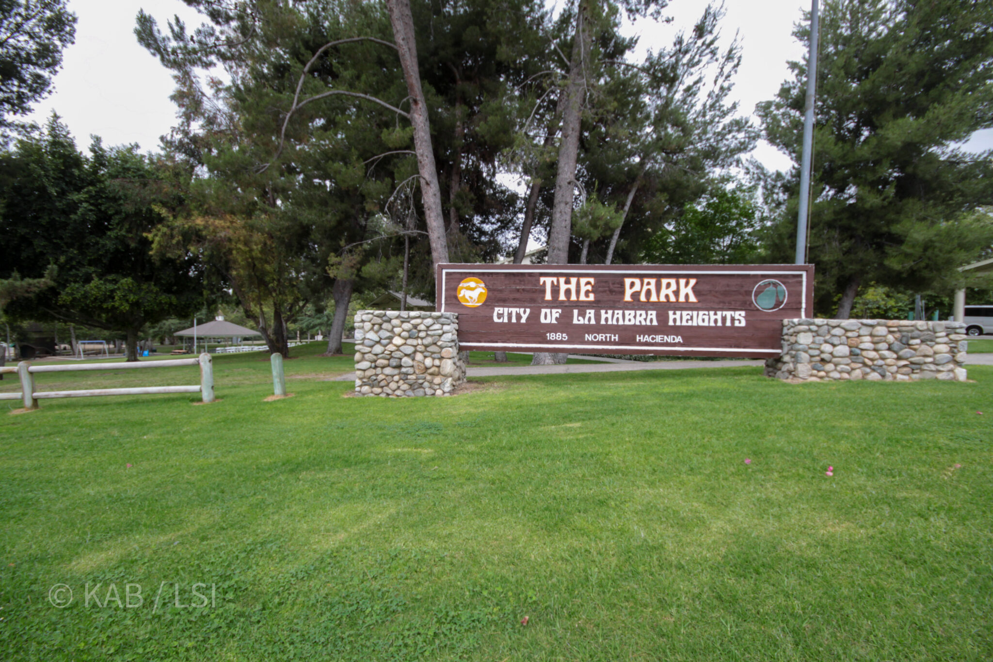 The Park, City of La Habra Heights wood sign at 1885 North Hacienda — the city park entrance with stone walls and tall pines