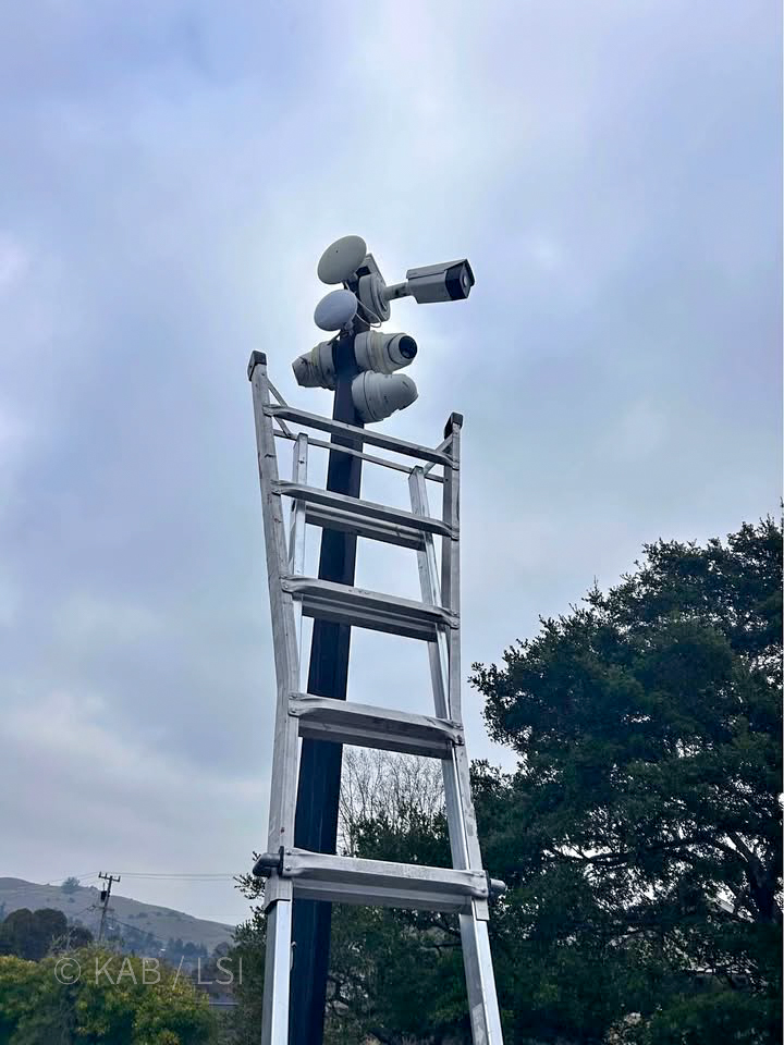 Multi-camera array mounted on a pole with stepladder access on a La Habra Heights property